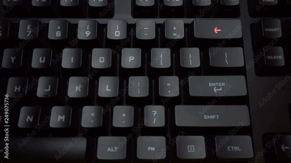 Key blinks Backspace on glowing computer keyboard Key blinks Backspace on glowing computer keyboard