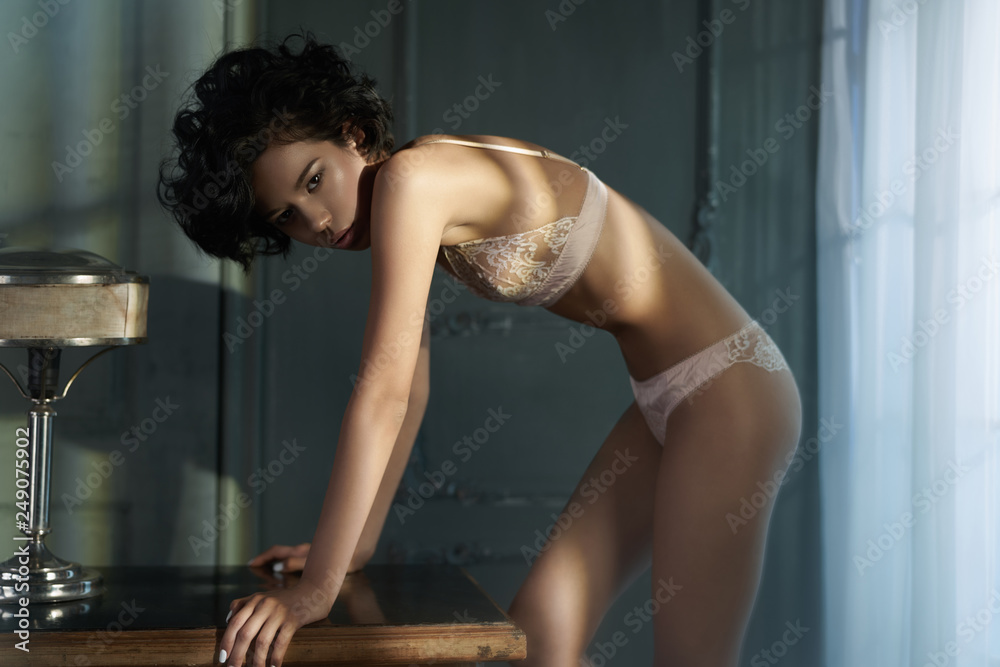 beautiful woman in sexy lingerie pose in home interior Stock Photo Adobe Stock image