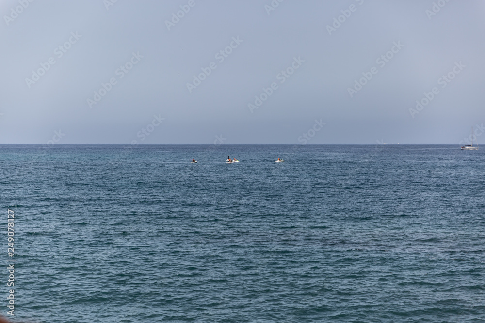 View of the sea with jet skis in the background