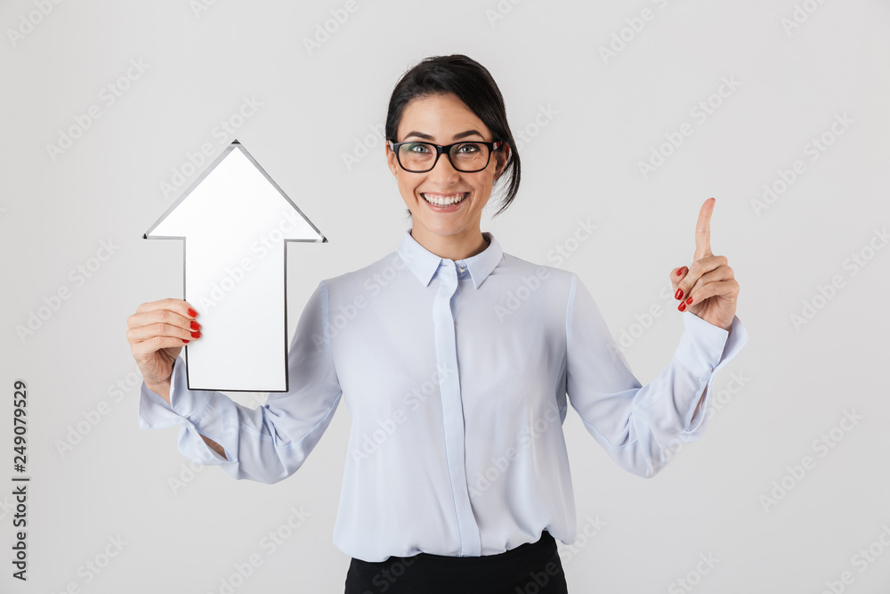Photo of businesslike office woman wearing eyeglasses holding blank arrow pointer, isolated over white background Photo of businesslike office woman wearing eyeglasses holding blank arrow pointer, isolated over white background