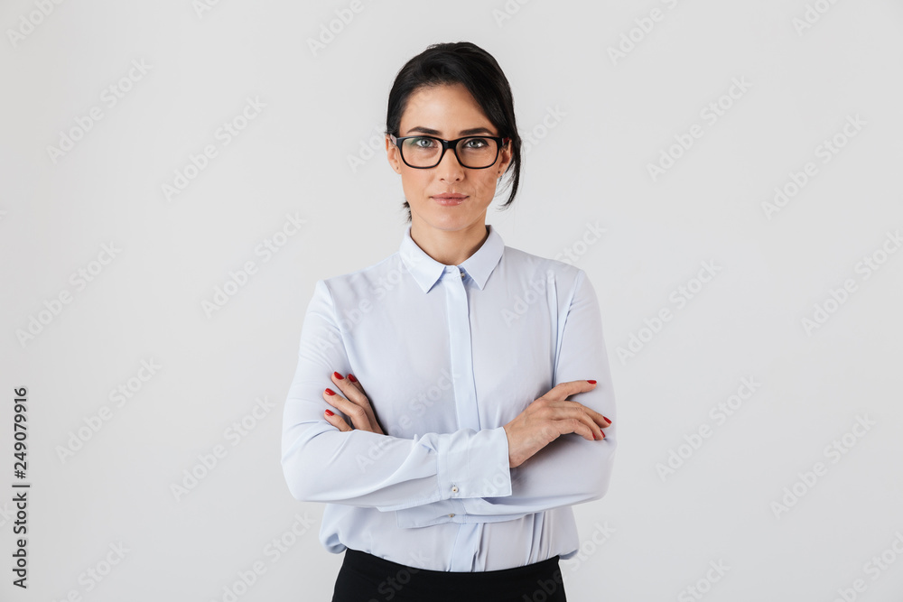 Photo of pretty businesswoman wearing eyeglasses standing in the office, isolated over white background Photo of pretty businesswoman wearing eyeglasses standing in the office, isolated over white background