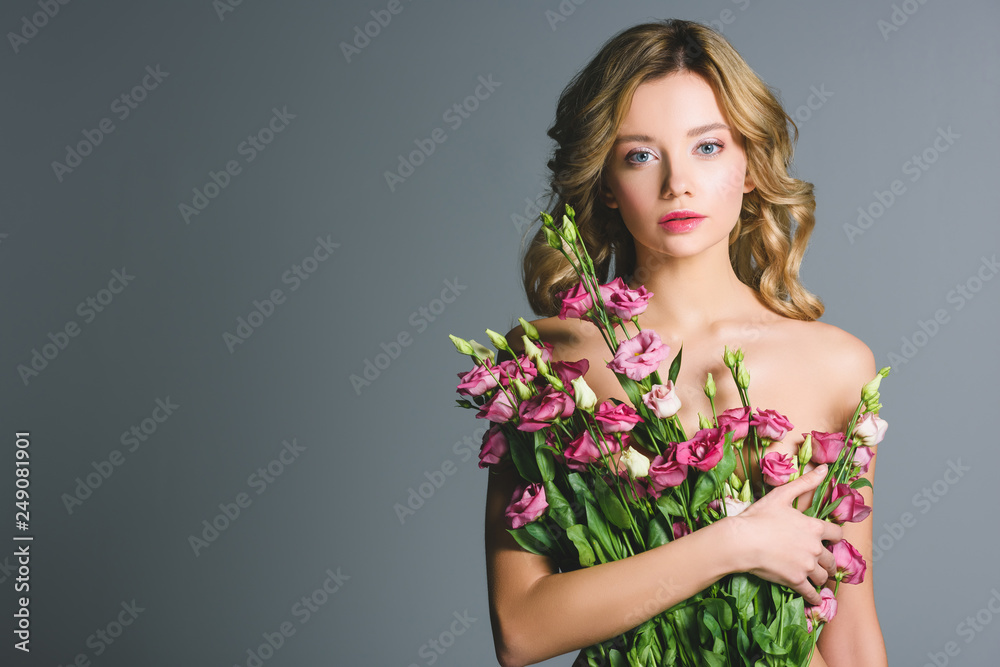 naked woman holding bouquet of eustoma flowers isolated on grey naked woman holding bouquet of eustoma flowers isolated on grey