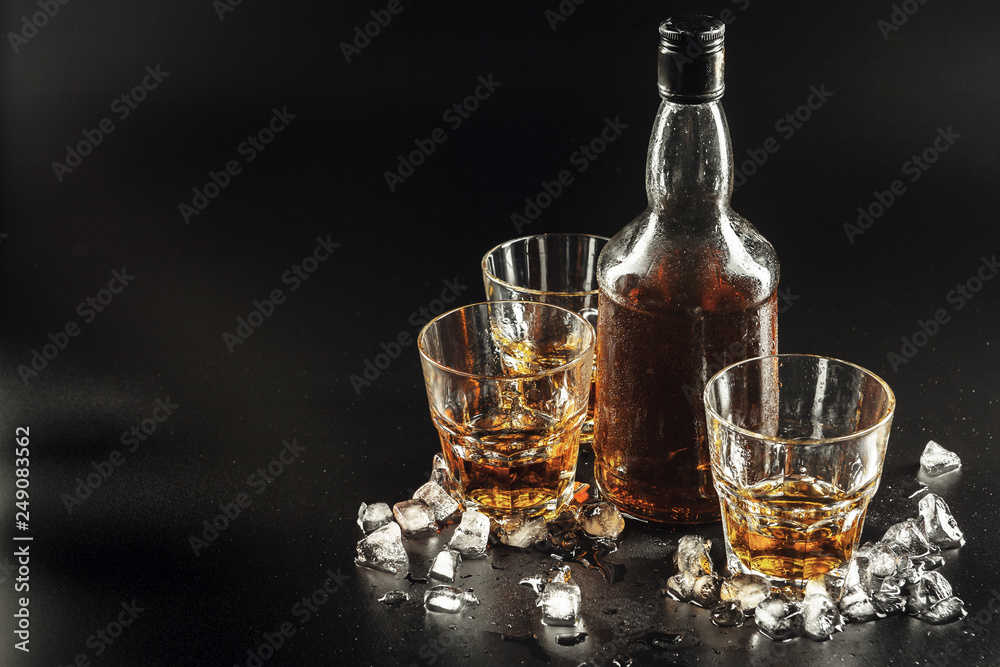 Glass of the whiskey and a square decanter Glass of the whiskey and a square decanter