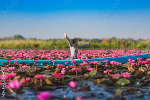 Bilde på lerret Young woman relaxing with beautiful lotus flower field at the Red Lotus Sea