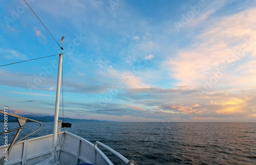 Lake Baikal. Nose and mast of the ship on the background of a beautiful sky with the setting sun. Journey and summer cruise. Natural background