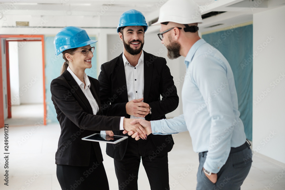 Engineers in hardhats have conversation Engineers in hardhats have conversation