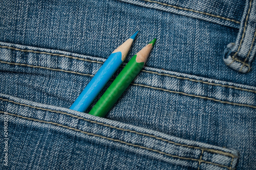 closeup of colouring pencils in blue jeans pocket