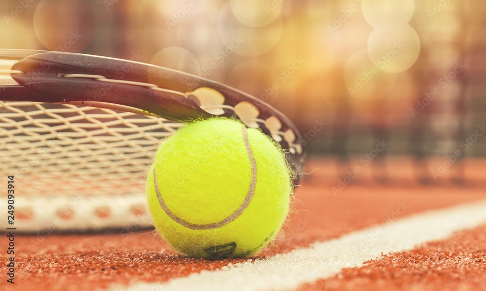 Tennis game. Tennis ball and racket on court background