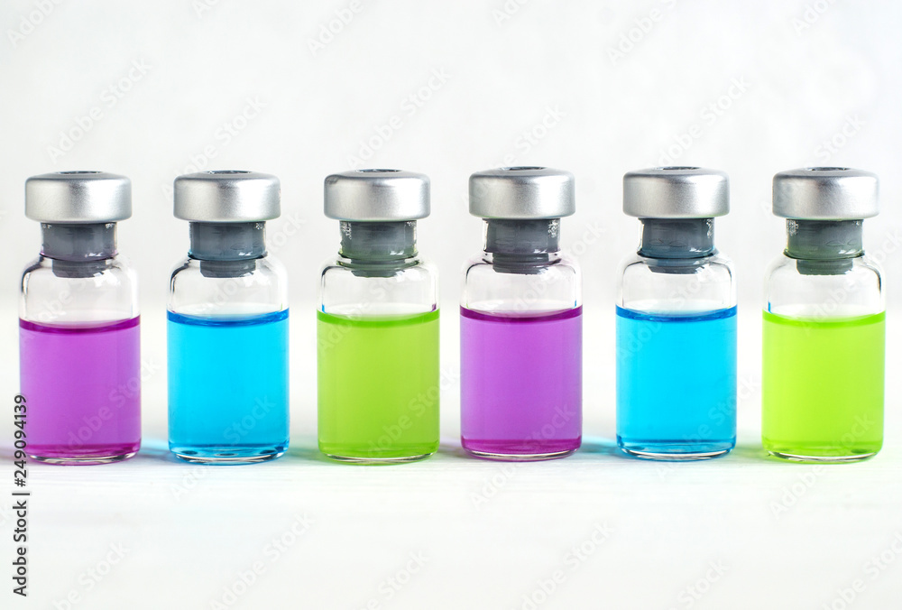Set of various medical vials for injections. Ampoules with liquid medication blue, pink and green colors. Small bottles with injection of youth. Set of various medical vials for injections. Ampoules with liquid medication blue, pink and green colors. Small bottles with injection of youth.