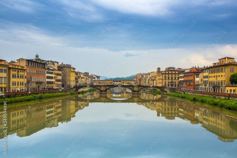 Dramatic dark blue sky over the beautiful city of Florence. Ponte Vecchio and Arno river. Florence colorful cityscape. Florence, Italy.