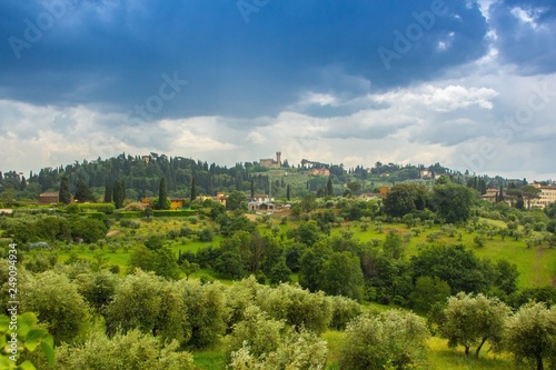Beautiful view of the Tuscany fields from the top of the hill at Boboli Garden. Rainy cloudy clouds over the beautiful Tuscan landscape. Florence  Italy.