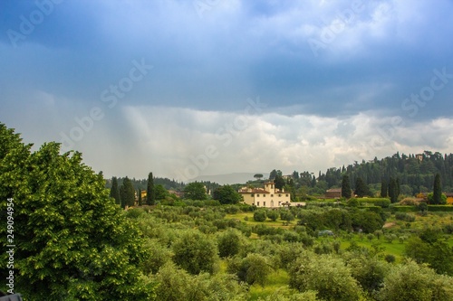 Beautiful view of the Tuscany fields from the top of the hill at Boboli Garden. Rainy cloudy clouds over the beautiful Tuscan landscape. Florence  Italy.