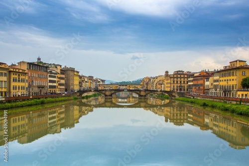 Dramatic dark blue sky over the beautiful city of Florence. Ponte Vecchio and Arno river. Florence colorful cityscape. Florence, Italy. © nikkusha