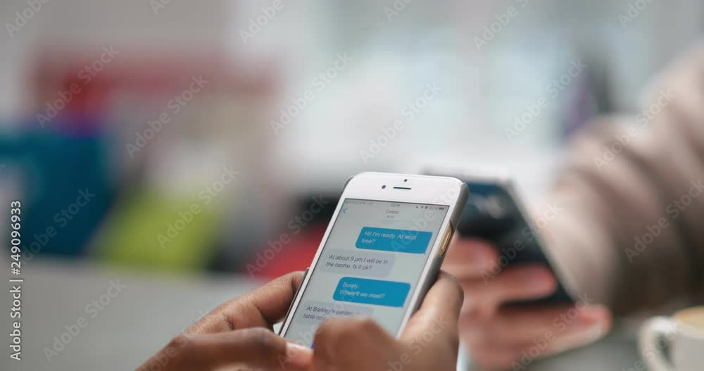 Female hands holding smartphone with open chat in messenger on screen Female hands holding smartphone with open chat in messenger on screen