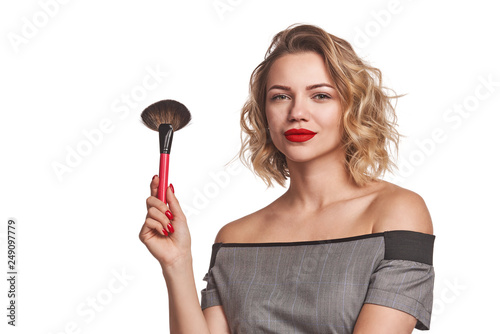 Slika na platnu Fashionable woman stylist standing posing with makeup brush