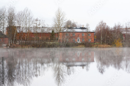 KOUVOLA, FINLAND - OCTOBER 23, 2018: Beautiful wooden Rabbelugn Manor - Takamaan Kartano in fog autumn day. Wrede family house was built in 1820 on the river Kymijoki bank