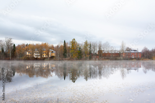 KOUVOLA, FINLAND - OCTOBER 23, 2018: Beautiful wooden Rabbelugn Manor - Takamaan Kartano in fog autumn day. Wrede family house was built in 1820 on the river Kymijoki bank photo