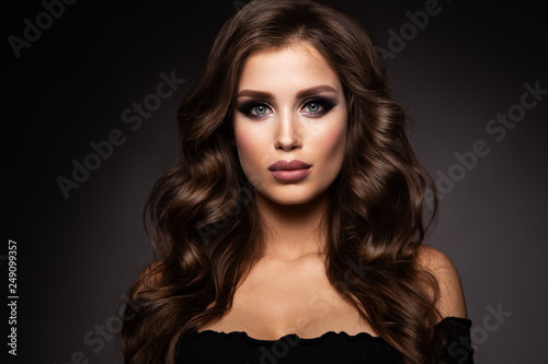 Beautiful woman with professional make up and curly hair