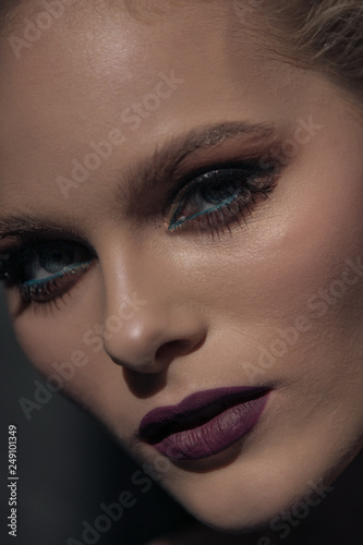 Fashionable portrait of a girl model with professional make-up face close-up
