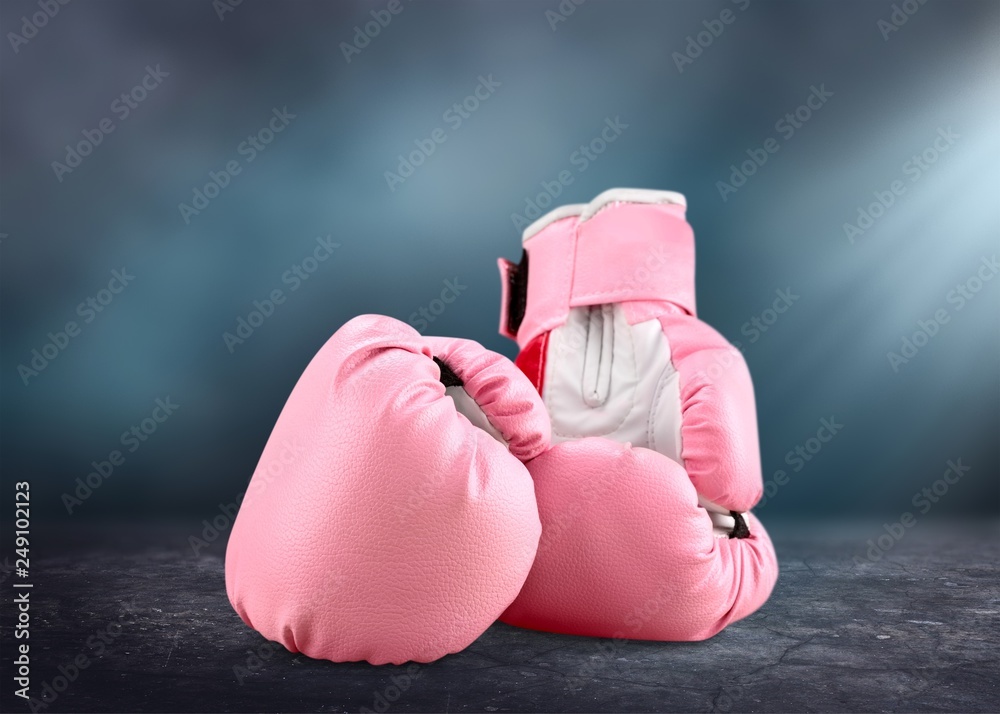 Pink boxing gloves on background
