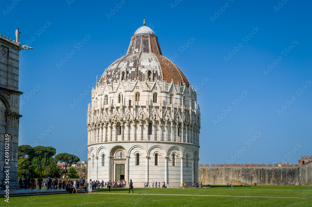 Tourist's queue to Pisa Baptistery - popular heritage of old Pisa. Tuscany, Italy.