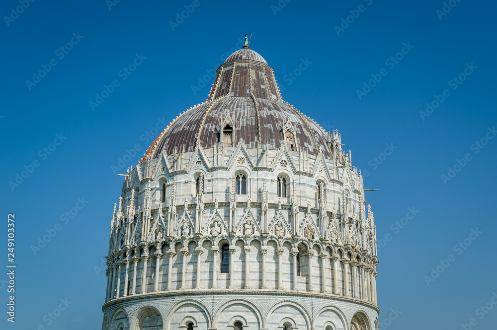 Pisa Baptistery decoration close view with blue sky background. Toscana, Italy