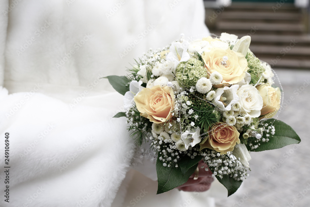 closeup of bride holding wedding bouquet of white roses