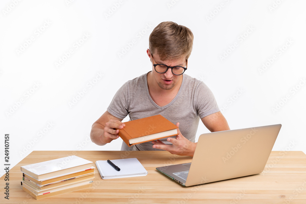 People and education concept - Handsome male student with a textbook People and education concept - Handsome male student with a textbook