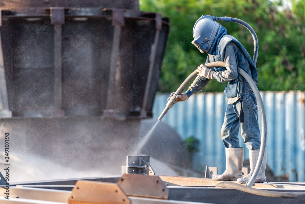 Sand blasting process, Industial worker using sand blasting process