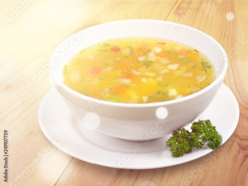 Bowl of delicious vegetables soup on table
