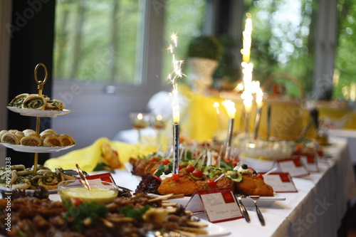 festive table setting with dirfferent plates of food decorated with sparklers firework