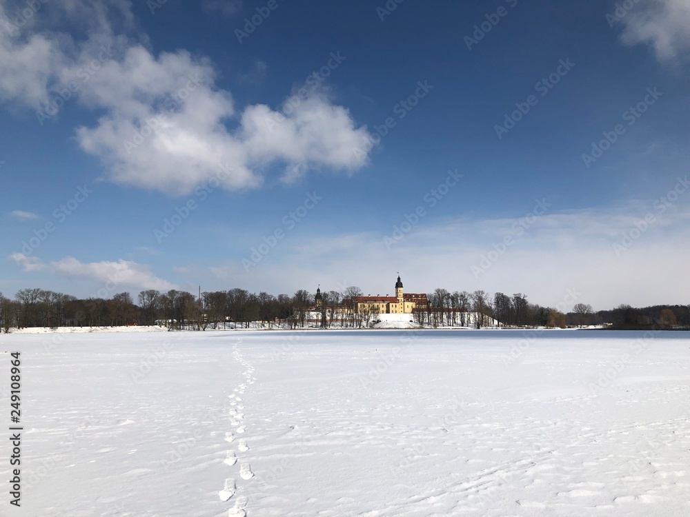 Nesvizh Castle, Belarus in winter as seen from across the frozen pond