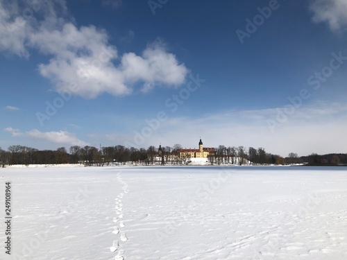Nesvizh Castle, Belarus in winter as seen from across the frozen pond