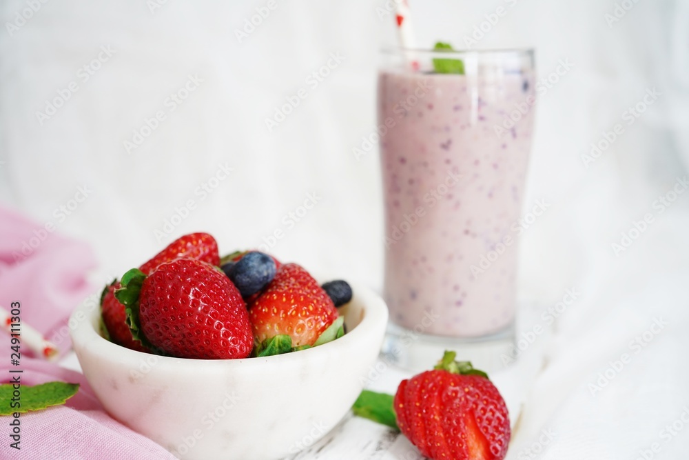 Homemade Strawberry blueberry Smoothie in a tall glass, selective focus Homemade Strawberry blueberry Smoothie in a tall glass, selective focus