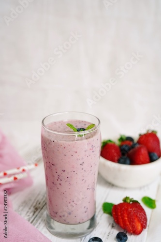 Homemade Strawberry blueberry Smoothie in a tall glass, selective focus