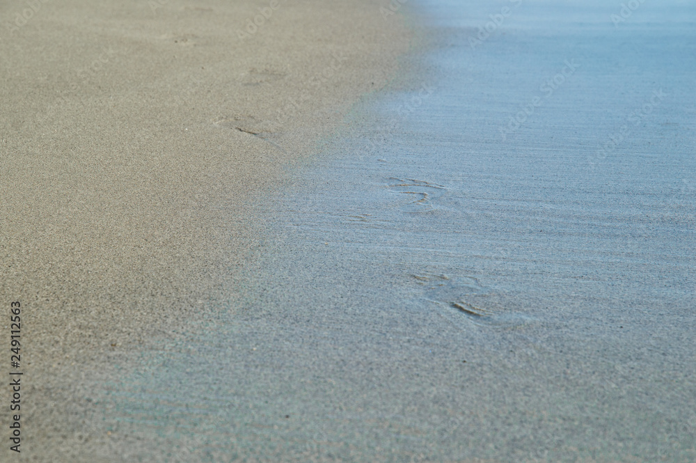 Close up. Italy, Rome, Ostia. Coast of the Tyrrhenian Sea. Footprints in the wet sea sand. Copy space. Close up. Italy, Rome, Ostia. Coast of the Tyrrhenian Sea. Footprints in the wet sea sand. Copy space.