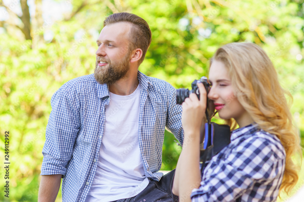 Man and woman having date outdoor. Girl wit a photo camera and her boyfriend. Man and woman having date outdoor. Girl wit a photo camera and her boyfriend.