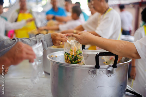 Feeding the poor to hands of a beggar   The concept of hunger or poverty