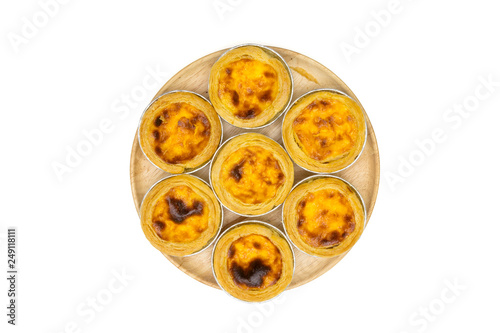 egg tart in aluminum foil cup on wooden dish, isolated on white background