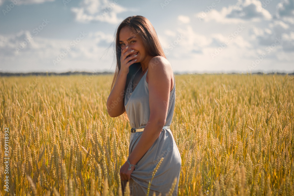beautiful woman in silver dress on a field beautiful woman in silver dress on a field