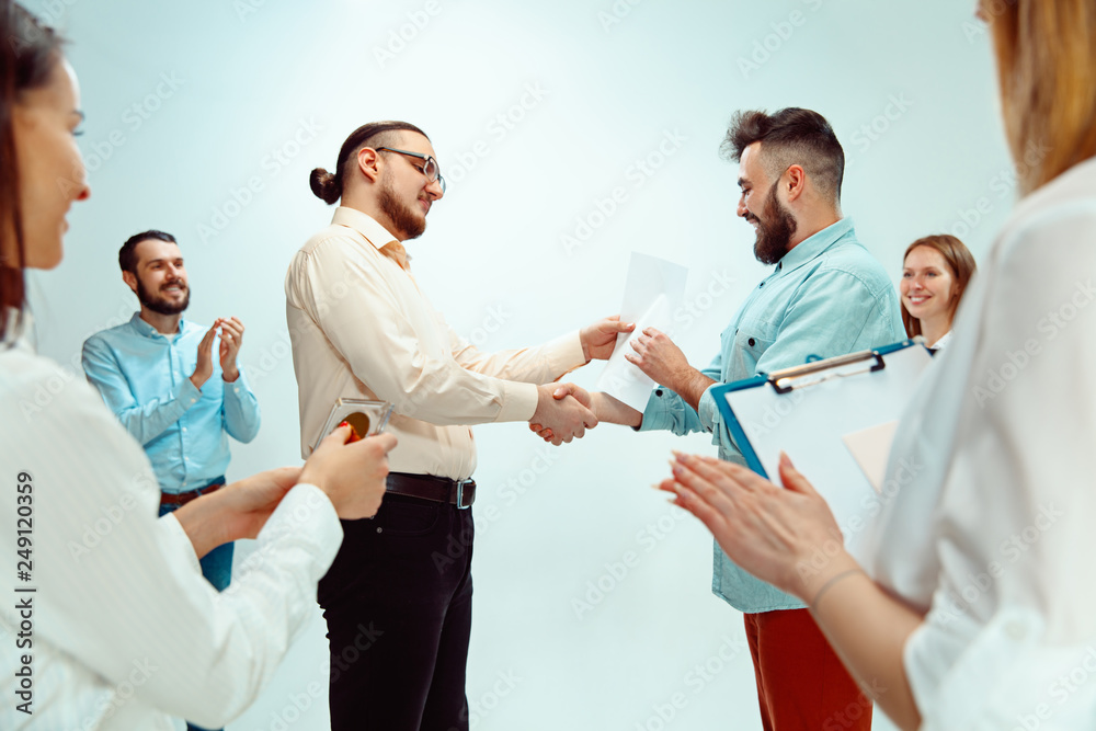 Obraz premium Boss approving and congratulating young successful employee of the company for his successes and good work. National Employee Appreciation Day, businesswoman, businessman, business, success, admire