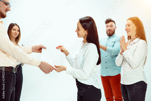Φωτογραφία Boss approving and congratulating young successful employee of the company for her successes and good work