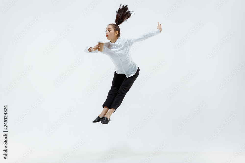 Happy businesswoman dancing and smiling in motion isolated on white studio background. Flexibility and grace in business. Human emotions concept. Office, success, professional, happiness, expression Happy businesswoman dancing and smiling in motion isolated on white studio background. Flexibility and grace in business. Human emotions concept. Office, success, professional, happiness, expression