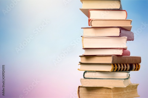 Stack of colorful books on background