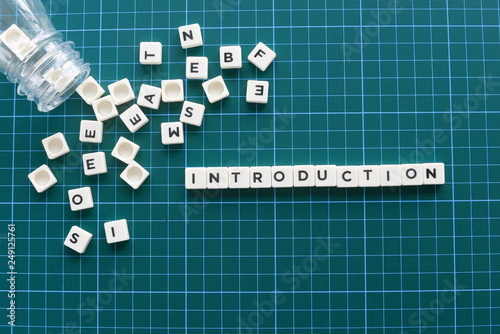 Introduction word made of square letter word on green background.