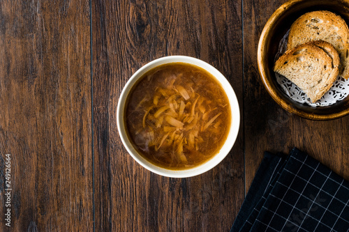 French Onion Soup with Bread on Dark Wooden Surface.