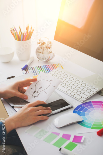 Young Handsome Graphic designer using graphics tablet to do his work at desk