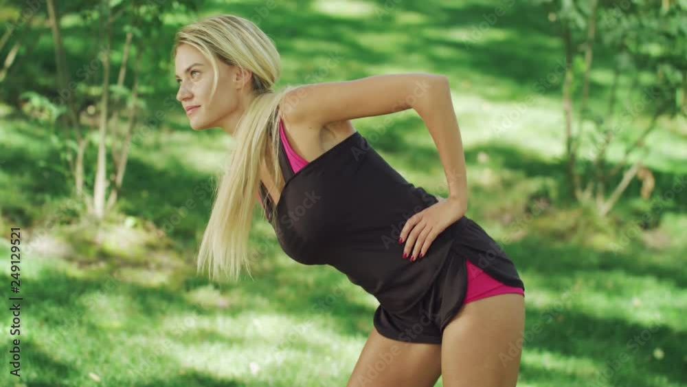 Fitness woman doing warm up exercise at sport training. Stretching workout Fitness woman doing warm up exercise at sport training. Stretching workout