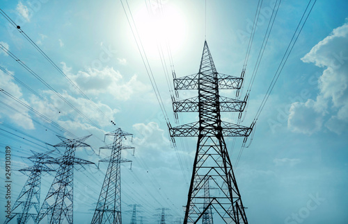 Photography High voltage towers against blue sky on sunny day