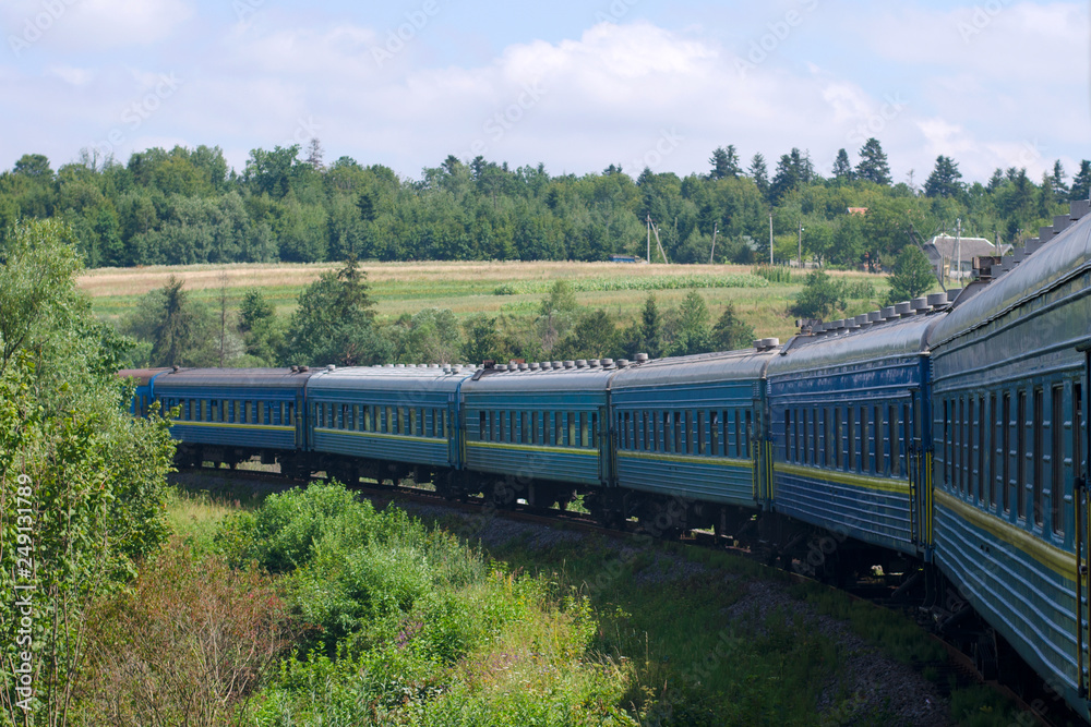 Fototapeta premium The long train moves to the mountains